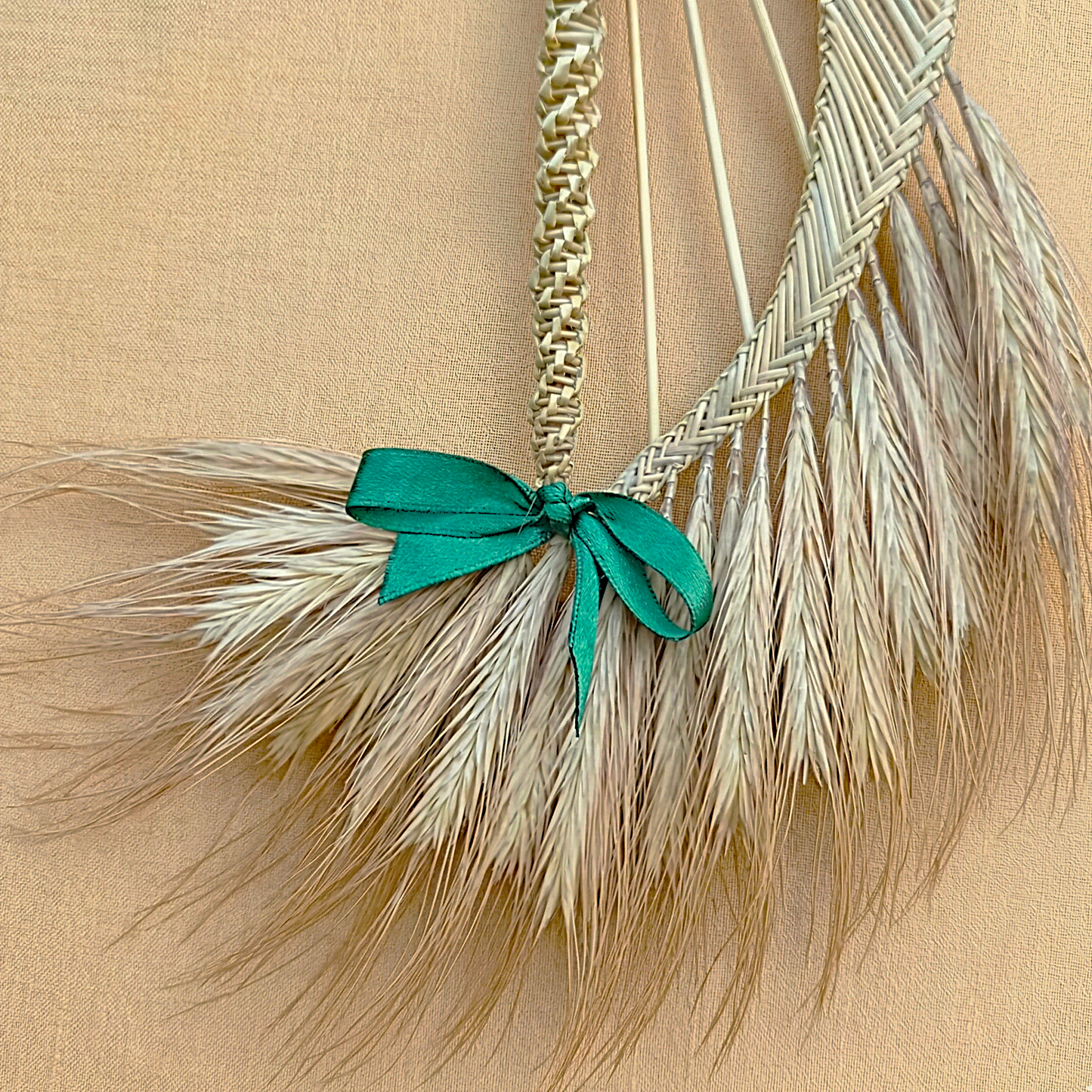 Natural straw harp ornament hanging on Christmas tree branch