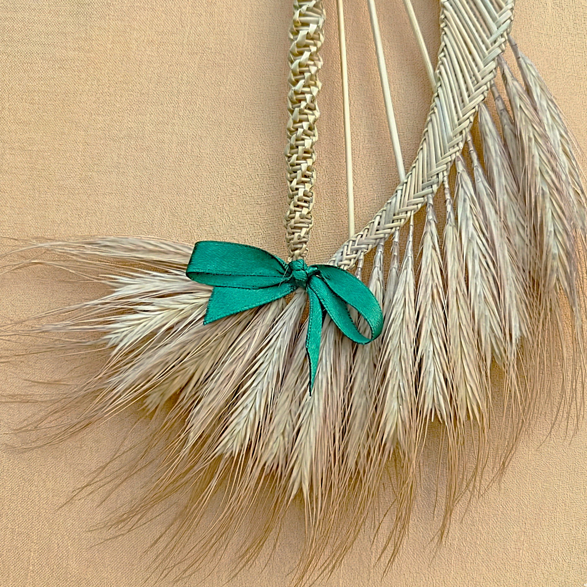 Natural straw harp ornament hanging on Christmas tree branch