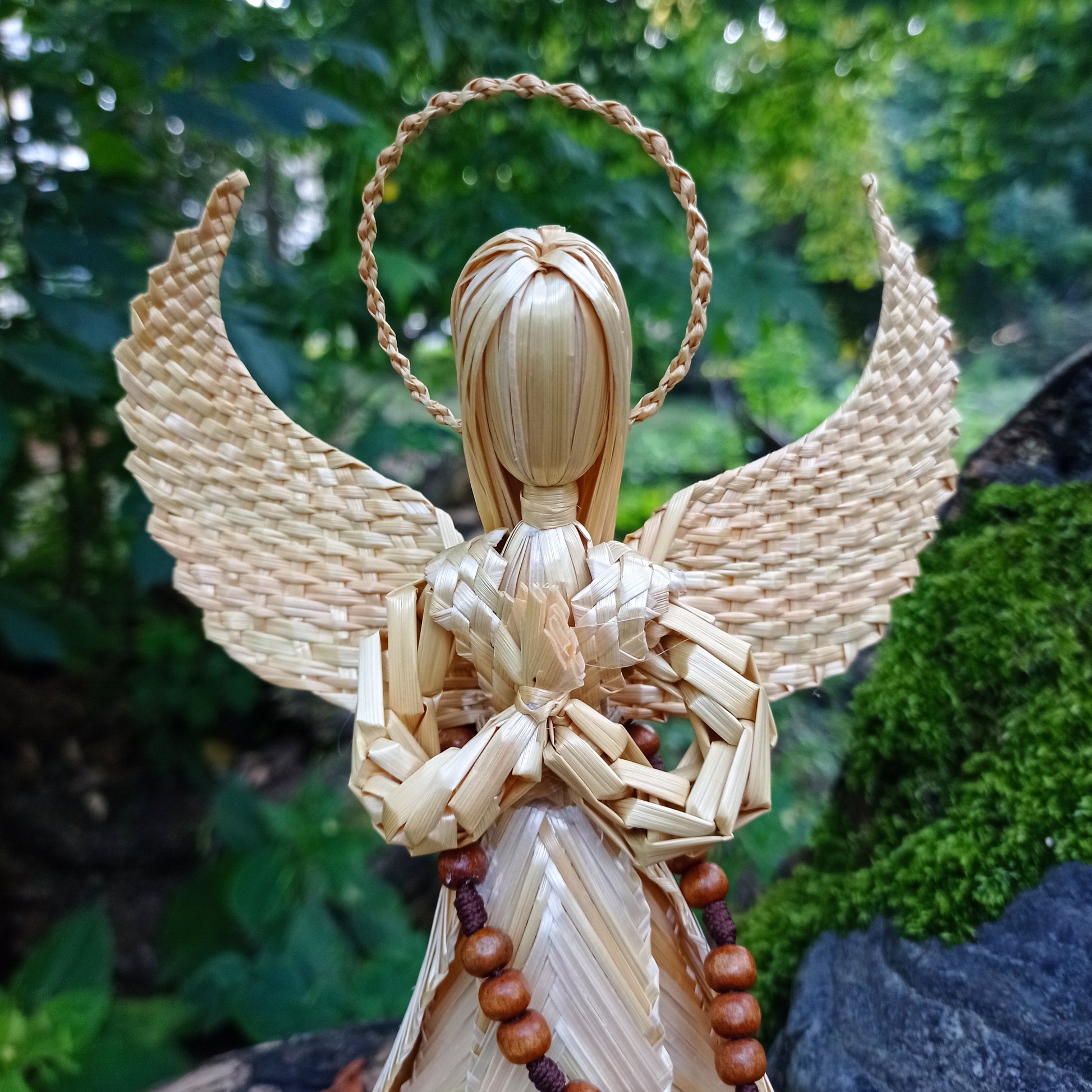 Standing straw angel figurine with halo and rosary, traditional Christmas folk art decoration