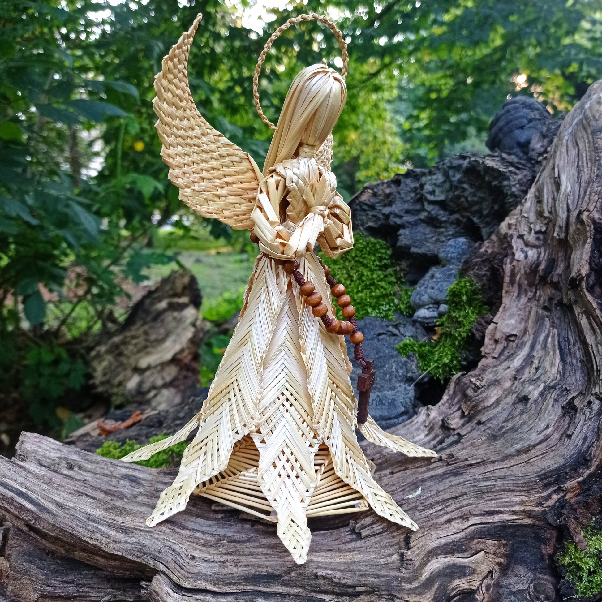 Christian straw angel with folded hands and wooden cross, rustic Christmas home decoration