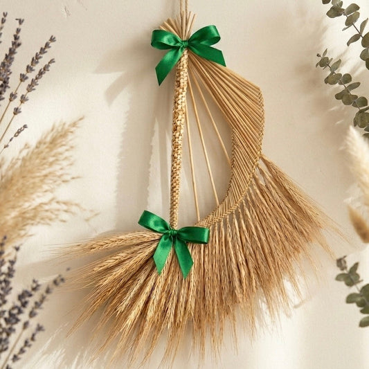 Handmade straw Celtic harp ornament hanging on Christmas tree with satin ribbon
